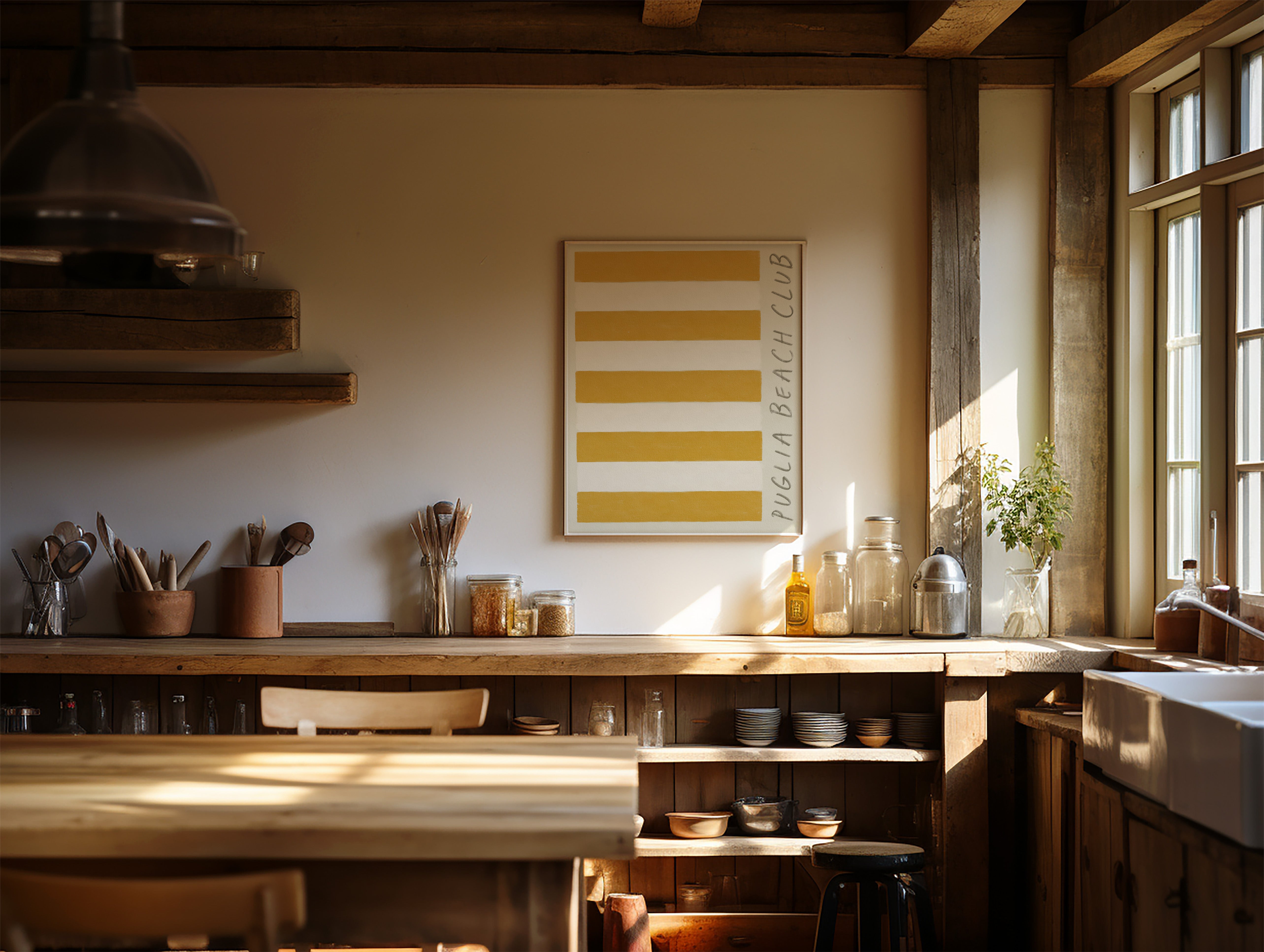 puglia beach club stripe giclée art print of original oil painting. puglia beach club stripe is a replica of the famous beach cloth linen that lines mediterranean coastlines. in a deep golden yellow ochre with rough mark my words font scribbled in crayon to the right hand side. Art print is hung in a traditional italian wooden beam kitchen in the hills of tuscany. the kitchen features rustic wood, local pottery and traditional utensils. it is bright and sun drenched.