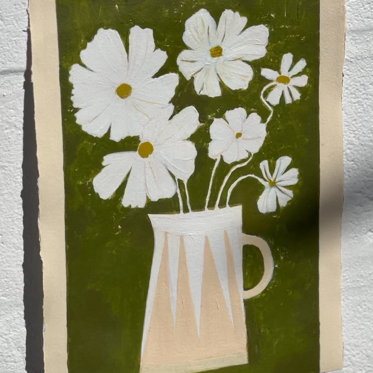White cosmos flowers in stripe modern vase against green brushstroke background.