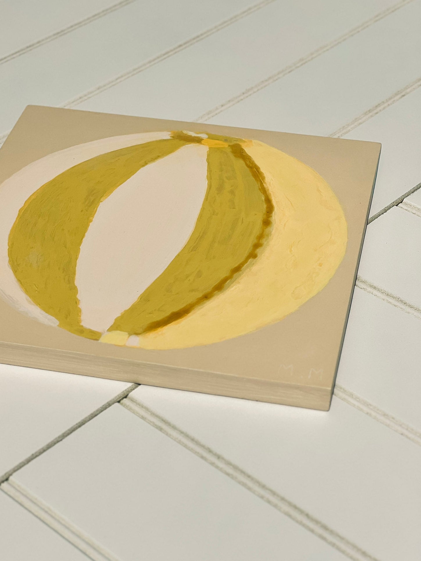 Green, cream, yellow painting of summer beach ball on reinforced plywood panel by contemporary Cornwall Artist Mila May.