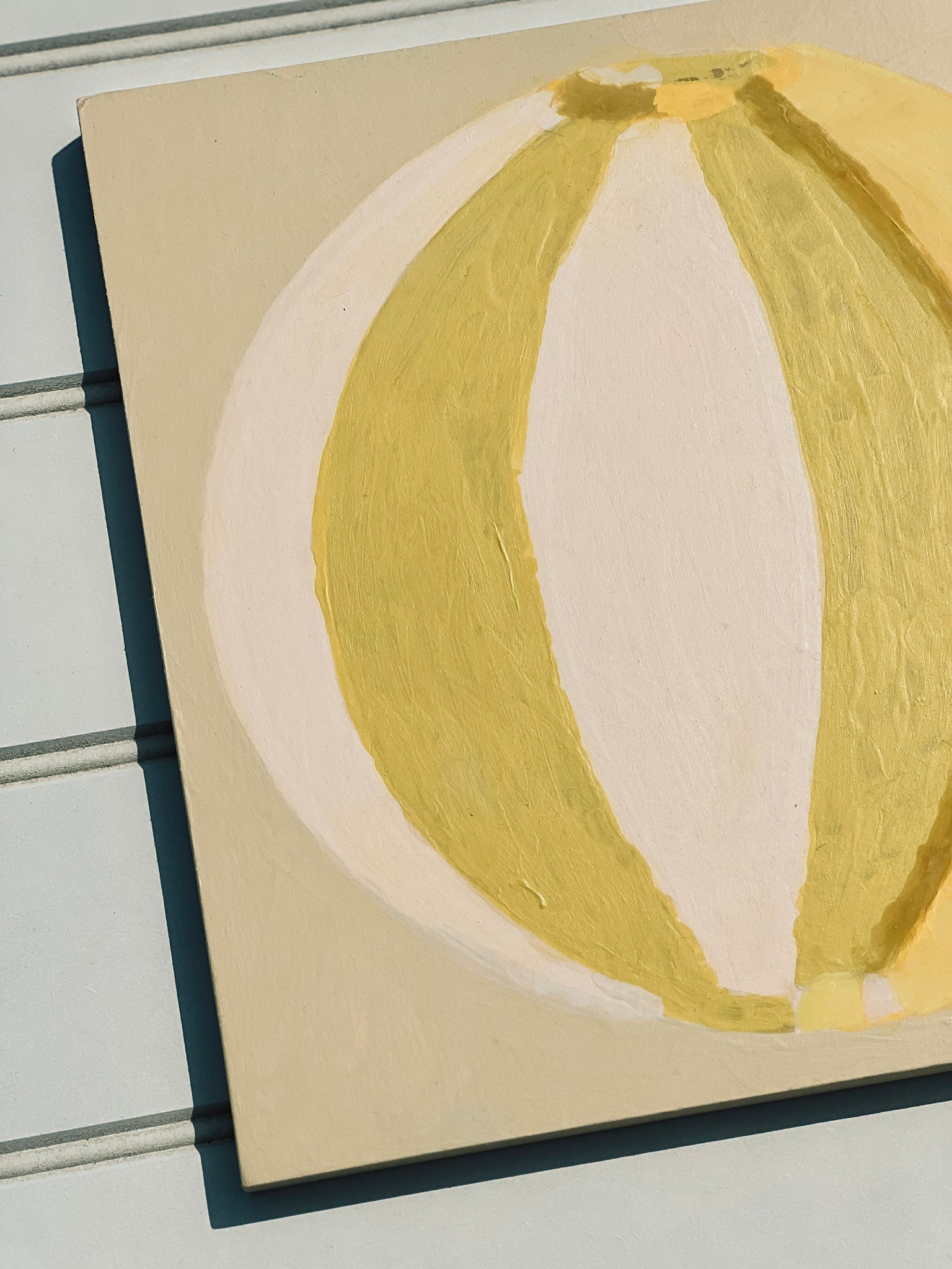 Green, cream, yellow abstract painting of summer beach ball on reinforced plywood panel by contemporary Cornwall Artist Mila May.