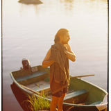 film camera 35mm man with beard by wood sail boat by sea