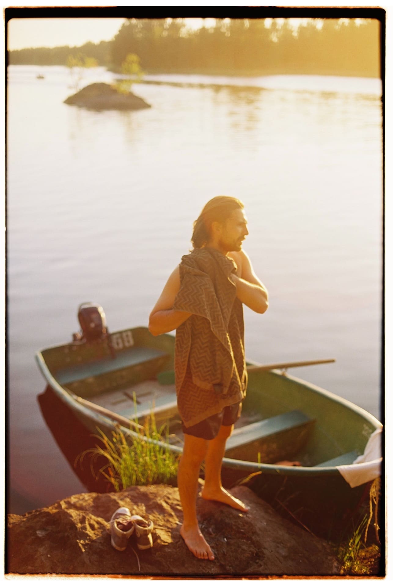 film camera 35mm man with beard by wood sail boat by sea