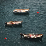 wood boats and neon buoys in crystal blue mediterranean sea