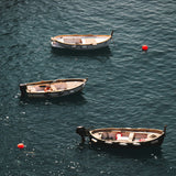 wood boats and neon buoys in crystal blue mediterranean sea