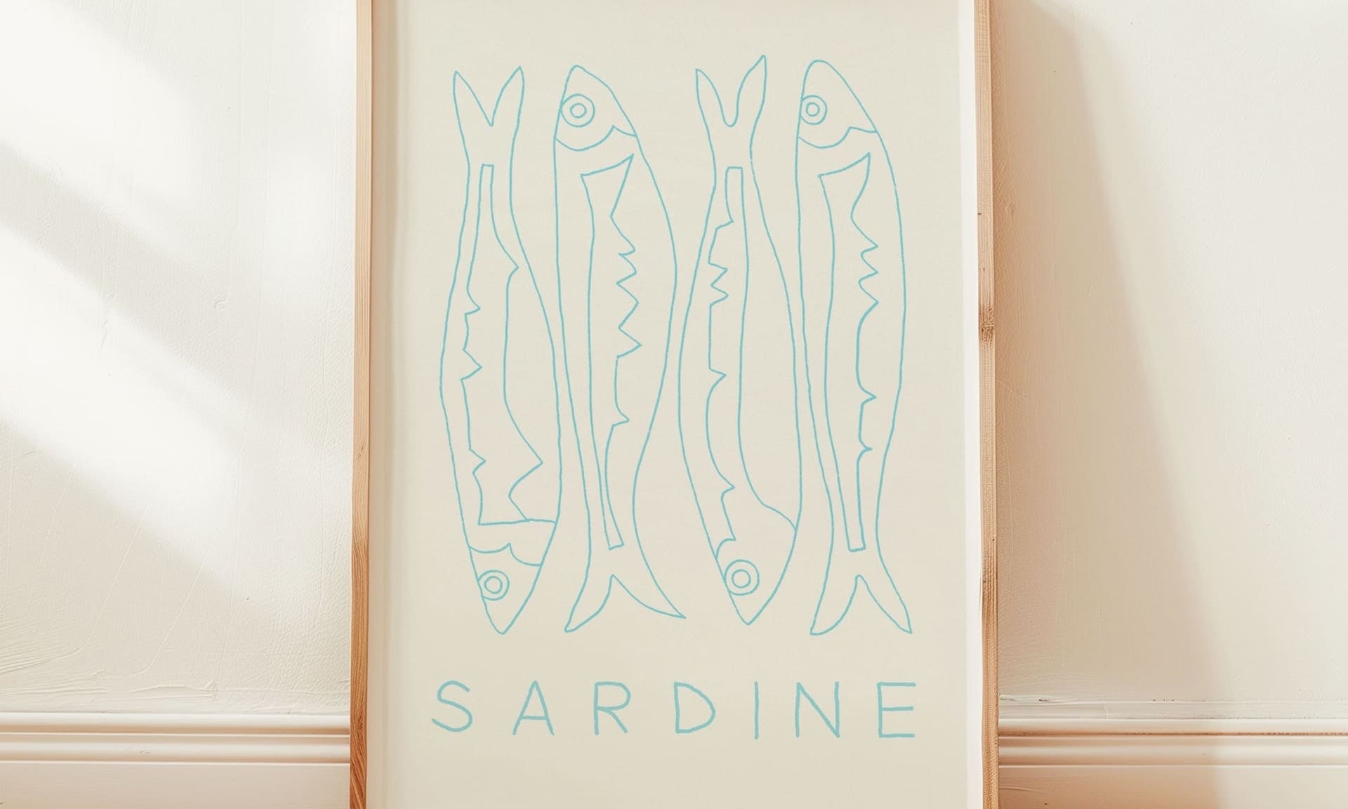 sardine fish art print with white mount in pine wood frame in sunny room