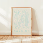 sardine fish art print with white mount in pine wood frame in sunny room